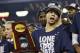 Connecticut guard Shabazz Napier holds the championship trophy after defeating Kentucky 60-54, at the NCAA Final Four tournament college basketball championship game Monday, April 7, 2014, in Arlington, Texas. (AP Photo/David J. Phillip)