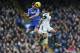 Chelsea's Branislav Ivanovic, left, jumps for the ball with a Swansea City player during their English Premier League soccer match at the Stamford Bridge ground in London, Thursday, Dec. 26, 2013. Chelsea won the match 1-0.(AP Photo/Lefteris Pitarakis)
