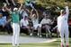 Tennis player Caroline Wozniacki and her fiancee Rory McIlroy, of Northern Ireland, celebrate after Wozniacki putted on the ninth hole during the par three competition at the Masters golf tournament Wednesday, April 9, 2014, in Augusta, Ga. (AP Photo/David J. Phillip)