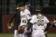 Oakland Athletics pitcher Jim Johnson (45) is relieved by manager Bob Melvin, rear, during the ninth inning of a baseball game against the Cleveland Indians in Oakland, Calif., Wednesday, April 2, 2014. The Indians won 6-4. Johnson was the losing pitcher. In front is Athletics catcher Derek Norris. (AP Photo/Jeff Chiu)