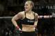 FILE - In this Feb. 22, 2014, file photo, Ronda Rousey looks around after defeating Sara McMann in a UFC 170 mixed martial arts women's bantamweight title bout in Las Vegas. Gina Carano was scheduled to meet with UFC President Dana White on Wednesday April 9, to discuss a return to mixed martial arts for a potential bout with bantamweight champion Rousey. (AP Photo/Isaac Brekken, File)