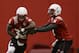 Nebraska quarterback Tommy Armstrong Jr., right, fakes a handoff to running back Imani Cross (32) on the first day of sping NCAA college football practice in Lincoln, Neb., Saturday, March 8, 2014. (AP Photo/Nati Harnik)