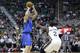Utah Jazz's Marvin Williams (2) defends against Dallas Mavericks' Dirk Nowitzki (41) as he shoots in the first quarter during an NBA basketball game Tuesday, April 8, 2014, in Salt Lake City. (AP Photo/Rick Bowmer)