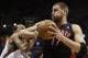 Toronto Raptors' Jonas Valanciunas (17) drives against Milwaukee Bucks' John Henson during the first half of an NBA basketball game Saturday, April 5, 2014, in Milwaukee. (AP Photo/Jeffrey Phelps)