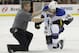 St. Louis Blues right wing T.J. Oshie (74) tries to get up with help from a trainer but can't after being injured during the second period of an NHL hockey game against the Minnesota Wild in St. Paul, Minn., Thursday, April 10, 2014. (AP Photo/Ann Heisenfelt)