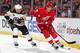 DETROIT, MI - APRIL 2: Danny DeKeyser #65 of the Detroit Red Wings skates with the puck as Brad Marchand #63 of the Boston Bruins puts a stick on him during an NHL game on April 2, 2014 at Joe Louis Arena in Detroit, Michigan. (Photo by Dave Reginek/NHLI via Getty Images)