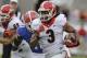Georgia running back Todd Gurley (3) runs for 25-yards past Florida linebacker Neiron Ball (11) during the first half of an NCAA college football game in Jacksonville, Fla., Saturday, Nov. 2, 2013.(AP Photo/John Raoux)