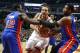 Chicago Bulls center Joakim Noah, center, is fouled as he drives the lane between Detroit Pistons guard Will Bynum (12) and center Andre Drummond during the first half of an NBA basketball game, Wednesday, Jan. 23, 2013, in Chicago. (AP Photo/Charles Rex Arbogast)