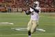 Central Florida running back Storm Johnson (8) celebrates as he scores untouched by Louisville defenders in the third quarter to tie the NCAA college football game in Louisville, Ky., Friday, Oct. 18, 2013. UCF came back to upset Louisville 38-35. (AP Photo/Garry Jones)