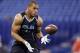 UCLA linebacker Anthony Barr makes a catch as he runs a drill at the NFL football scouting combine in Indianapolis, Monday, Feb. 24, 2014. (AP Photo/Michael Conroy)
