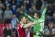 Arsenal's Thomas Vermaelen celebrates with Lukasz Fabianski, at the end of their English FA Cup semifinal soccer match against Wigan Athletic, at the Wembley Stadium in London, Saturday, April 12, 2014. (AP Photo/Bogdan Maran)