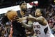 Miami Heat forward LeBron James, left, tries to keep the ball away from the defense of Atlanta Hawks forward Cartier Martin (20) during the second half of an NBA basketball game on Saturday, April 12, 2014, in Atlanta. Atlanta won 98-85. (AP Photo/John Amis)