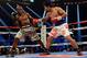 Apr 12, 2014; Las Vegas, NV, USA; Timothy Bradley Jr.(brown gloves) and Manny Pacquiao (red gloves) during their WBO World Welterweight Championship fight at MGM Grand Garden Arena. Mandatory Credit: Jayne Kamin-Oncea-USA TODAY Sports