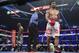 Manny Pacquiao, right, of the Philippines, and Timothy Bradley, are sent to their corners by referee Kenny Bayless at the end of a round of the WBO welterweight title boxing bout Saturday, April 12, 2014, in Las Vegas. (AP Photo/Eric Jamison)