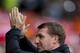 Liverpool's manager Brendan Rodgers applauds supporters as he takes to the touchline before his team's English Premier League soccer match against Tottenham at Anfield Stadium, Liverpool, England, Sunday March 30, 2014. (AP Photo/Jon Super)