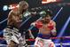 Timothy Bradley, left, lands a left to the head of Manny Pacquiao, of the Philippines, in their WBO welterweight title boxing fight Saturday, April 12, 2014, in Las Vegas. (AP Photo/Eric Jamison)