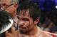 Manny Pacquiao, of the Philippines, looks across the ring following his unanimous decision over Timothy Bradley in their WBO welterweight title boxing fight Saturday, April 12, 2014, in Las Vegas. (AP Photo/Eric Jamison)