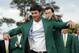 Defending Masters' champion Adam Scott, of Australia, helps Bubba Watson, left, with his green jacket after winning the Masters golf tournament Sunday, April 13, 2014, in Augusta, Ga. (AP Photo/David J. Phillip)