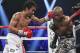 Manny Pacquiao, left, of the Philippines, drives Timothy Bradley into the ropes in their WBO welterweight title boxing bout Saturday, April 12, 2014, in Las Vegas. Pacquiao won by unanimous decision. (AP Photo/Isaac Brekken)