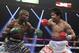 Timothy Bradley, left, trades blows with Manny Pacquiao, of the Philippines, in their WBO welterweight title boxing bout Saturday, April 12, 2014, in Las Vegas. (AP Photo/Isaac Brekken)