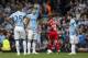 Manchester City's David Silva, right, Edin Dzeko, centre left, and Fernandinho wait for play to begin after Liverpool's second goal during their English Premier League soccer match at Anfield Stadium, Liverpool, England, Sunday April 13, 2014. Liverpool won the game 3-2 with the winning goal scored by Philippe Coutinho, centre right. (AP Photo/Jon Super)