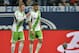 Wolfsburg's Kevin de Bruyne, left, comforts Wolfsburg's Daniel Caligiuri who leaves the pitch after getting a red card during the German Bundesliga soccer match between FC Schalke 04 and VfL Wolfsburg in Gelsenkirchen, Germany, Saturday, Feb. 1, 2014. (AP Photo/Martin Meissner)