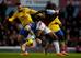 LONDON, ENGLAND - APRIL 15: Lukas Podolski of Arsenal shoots past Winston Reid of West Ham United to score their first goal during the Barclays Premier League match between Arsenal and West Ham United at Emirates Stadium on April 15, 2014 in London, England. (Photo by Paul Gilham/Getty Images)