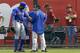 New York Mets' Curtis Granderson (3) is looked at by Mets training staff after Granderson tried to make a play on a ball hit by Arizona Diamondbacks' Miguel Montero in the first inning of a baseball game on Monday, April 14, 2014, in Phoenix. Granderson left the game early, but the Mets defeated the Diamondbacks 7-3. (AP Photo/Ross D. Franklin)