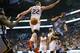 Memphis Grizzlies' Mike Conley (11) dishes off around Phoenix Suns' Miles Plumlee (22) to teammate Zach Randolph during the first half of an NBA basketball game, Monday, April 14, 2014, in Phoenix. (AP Photo/Matt York)