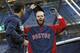 New York Yankees center fielder Jacoby Ellsbury, left, looks under the cap of Boston Red Sox's Dustin Pedroia after greeting his former teammates during batting practice before a baseball game between the teams at Yankee Stadium in New York, Thursday, April 10, 2014. (AP Photo/Kathy Willens)