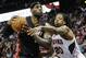 Miami Heat forward LeBron James, left, tries to keep the ball away from the defense of Atlanta Hawks forward Cartier Martin (20) during the second half of an NBA basketball game on Saturday, April 12, 2014, in Atlanta. Atlanta won 98-85. (AP Photo/John Amis)