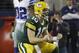 Green Bay Packers quarterback Matt Flynn (10) celebrates in front of Dallas Cowboys cornerback Orlando Scandrick (32) after the game wining touchdown during the fourth quarter of an NFL football game, Sunday, Dec. 15, 2013, in Arlington, Texas. The Packers won 37-36. (AP Photo/Tim Sharp)
