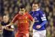 Liverpool's Philippe Coutinho, left, and Everton's James McCarthy battle for the ball during their English Premier League soccer match at Anfield in Liverpool, England, Tuesday Jan. 28, 2014. (AP Photo/Clint Hughes)