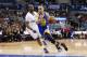 Golden State Warriors' Stephen Curry dribbles the ball around Los Angeles Clippers' Chris Paul during the first half of an NBA basketball game in Los Angeles, Wednesday, March 12, 2014. (AP Photo/Danny Moloshok)