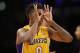 Los Angeles Lakers forward Nick Young puts his fingers around his eyes as he celebrates a three-pointer against the Portland Trail Blazers during the second half of an NBA basketball game in Los Angeles, Tuesday, April 1, 2014. (AP Photo/Danny Moloshok)
