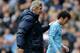 Manchester City manager Manuel Pellegrini, left, pats David Silva on the back after he is substituted during the English Premier League soccer match between Manchester City and Southampton at The Etihad Stadium, Manchester, England, Saturday, April 5, 2014. (AP Photo/Rui Vieira)
