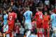 Liverpool's Jordan Henderson third right, is shown a red card by referee Mark Clattenburg left, after he fouls Manchester City's Samir Nasri during their English Premier League soccer match at Anfield in Liverpool, England, Sunday April. 13, 2014. (AP Photo/Clint Hughes)