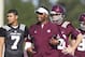 Texas A&M head coach Kevin Sumlin, center, smiles as he watches the team's NCAA college football practice, Monday, Aug, 5, 2013, in College Station, Texas. (AP Photo/Patric Schneider)