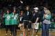 2013 Boston Marathon bombing survivor Karen Rand, center, waves to the cheering crowd as others injured in the blasts, Celeste Corcoran, left, and her daughter Sydney, second from left, and Roseann Sdoia, right, watch as they are honored during a break in an NBA basketball game between the Boston Celtics and the Washington Wizards in Boston, Wednesday, April 16, 2014. (AP Photo/Elise Amendola)