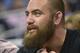UFC mixed martial arts fighter Travis Browne, of Albuquerque, N.M., watches from court side seats during the second half of an NBA basketball game between the Orlando Magic and Memphis Grizzlies in Orlando, Fla., Wednesday, Feb. 12, 2014. The Grizzlies won 86-81.(AP Photo/Phelan M. Ebenhack)