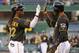 Pittsburgh Pirates' Andrew McCutchen (22) is greeted by teammate Starling Marte as he crosses home plate after hitting a two-run home run off Milwaukee Brewers starting pitcher Yovani Gallardo during the first inning of a baseball game in Pittsburgh, Thursday, April 17, 2014. (AP Photo/Gene J. Puskar)