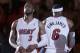 Miami Heat guard Dwyane Wade (3) and forward LeBron James (6) stand during player introductions before the start of an NBA basketball game against the Brooklyn Nets, Wednesday, March 12, 2014 in Miami. (AP Photo/Wilfredo Lee)
