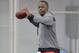 Louisville quarterback Teddy Bridgewater warms up before participating in passing drills for NFL representatives during pro day at the University of Louisville in Louisville, Ky., Monday, March 17, 2014. (AP Photo/Timothy D. Easley)