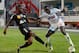 Stade de Reims' midfielder Prince Oniangue, left, challenges for the ball with Marseille's defender Benjamin Mendy during their League One soccer match, at the Velodrome Stadium, in Marseille, southern France, Saturday, Oct. 26, 2013. (AP Photo/Claude Paris)