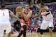 Chicago Bulls center Joakim Noah, center, drives to the basket against Washington Wizards' Trevor Ariza (1) and Trevor Booker (35) during the first half of an NBA basketball game, Saturday, April 5, 2014, in Washington. (AP Photo/Nick Wass)