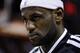 Miami Heat's LeBron James stands for the national anthem before an NBA basketball game against the Indiana Pacers, Friday, April 11, 2014, in Miami. (AP Photo/Lynne Sladky)