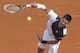 Novak Djokovic of Serbia serves the ball to Roger Federer of Switzerland during their semifinal match of the Monte Carlo Tennis Masters tournament in Monaco, Saturday, April 19, 2014. Federer won 7-6 6-2. (AP Photo/Michel Euler)