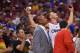 Los Angeles Clippers forward Blake Griffin, upper right, tosses water on a Golden State Warriors fan, far left, as he watches a replay after fouling out of the game while head coach Doc Rivers looks on during the second half in Game 1 of an opening-round NBA basketball playoff series against the Warriors, Saturday, April 19, 2014, in Los Angeles. The Warriors won 109-105. (AP Photo/Mark J. Terrill)