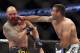 Fabricio Werdum, right, hits Travis Browne during a UFC mixed martial arts bout on Saturday, April 19, 2014, in Orlando, Fla. Werdum won. (AP Photo/Reinhold Matay)