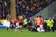 HULL, ENGLAND - APRIL 20: Players help clear advertising hoardings which had blown onto the pitch during the Barclays Premier League match between Hull City and Arsenal at KC Stadium on April 20, 2014 in Hull, England. (Photo by Matthew Lewis/Getty Images)